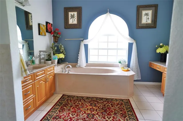 a bathroom with a bathtub sink and mirror