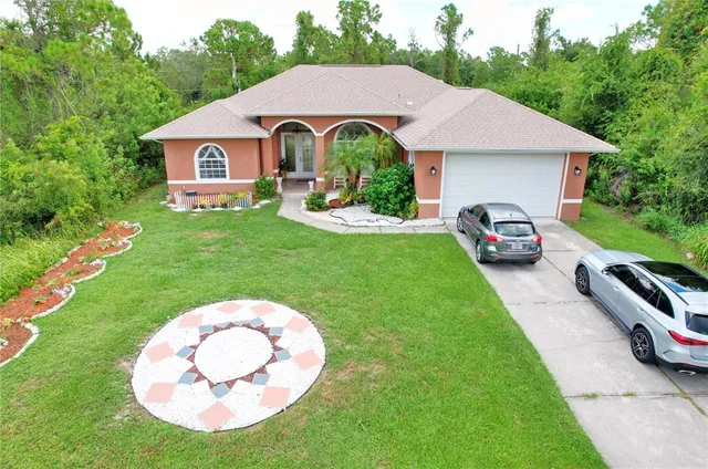 an aerial view of residential houses with outdoor space and trees