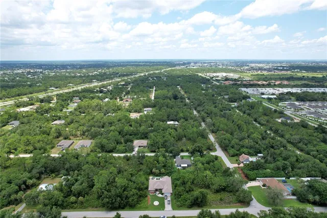 an aerial view of residential building with green space