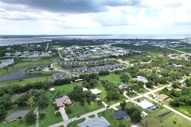 an aerial view of a house with a yard and plants
