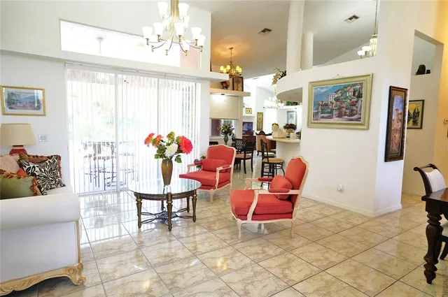 a view of a dining room with furniture and chandelier