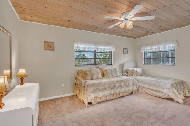 a spacious bedroom with a bed and a couch