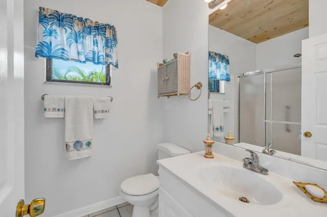 a bathroom with a sink mirror vanity and toilet