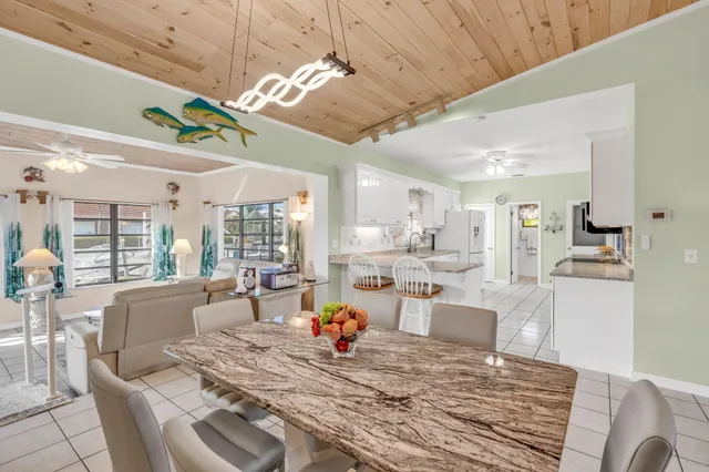 a living room with furniture appliances and a large window