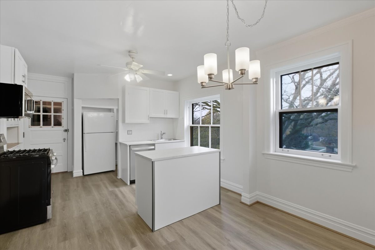1507 Dobson Street, Unit 3 Evanston, IL 60202 - Photo 4 of 14 a room with furniture a chandelier a large window and flat screen tv