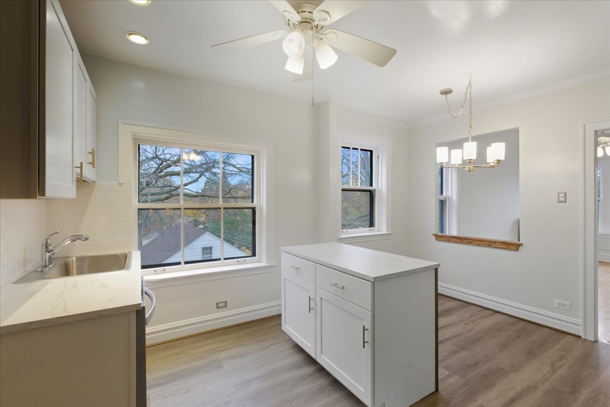1507 Dobson Street, Unit 3 Evanston, IL 60202 - Photo 7 of 14 a room with a chandelier furniture and a window
