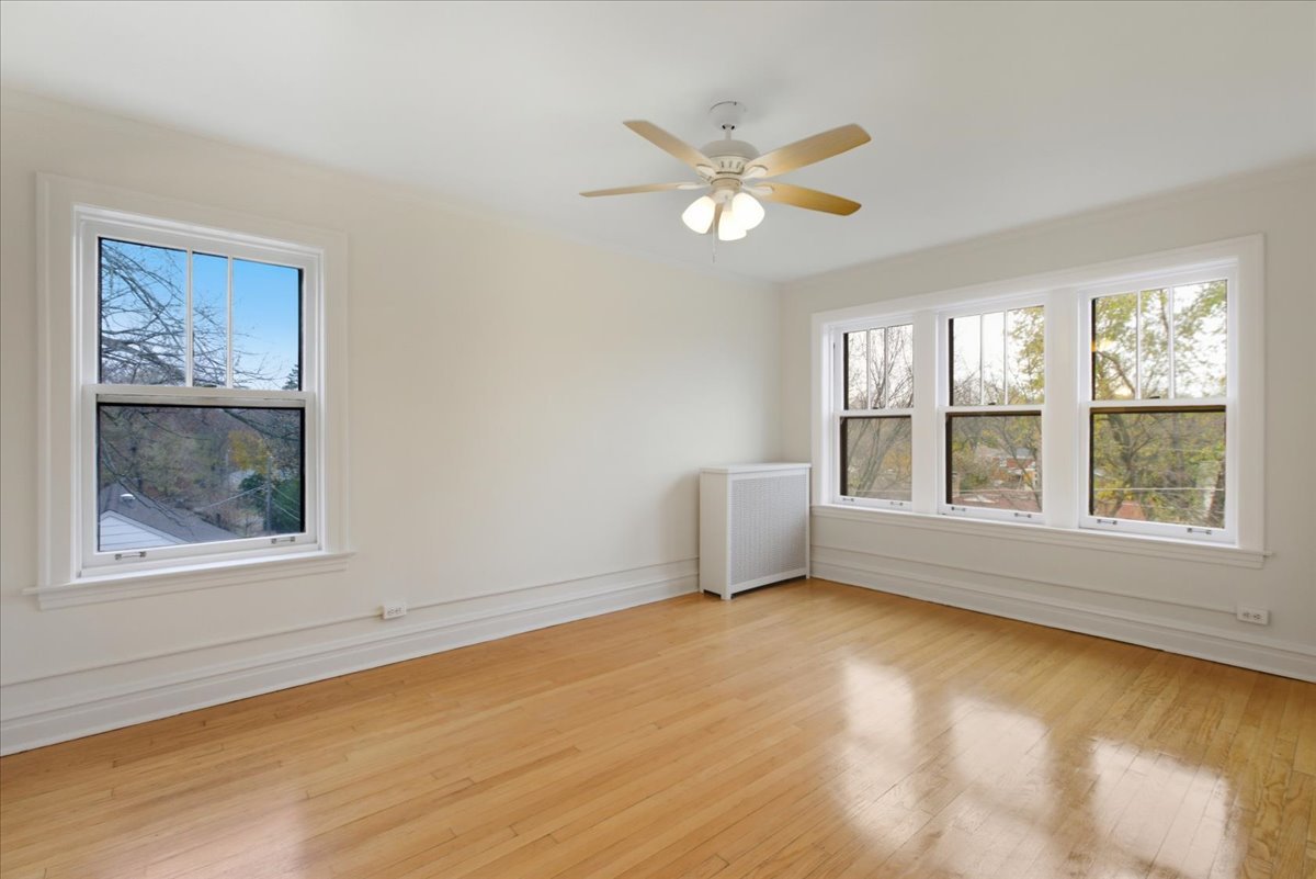 1507 Dobson Street, Unit 3 Evanston, IL 60202 - Photo 10 of 14 a view of an empty room with a window and wooden floor