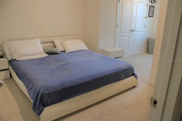 a bedroom with a bed and night stand