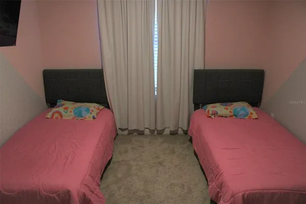 a bedroom with a bed and chair