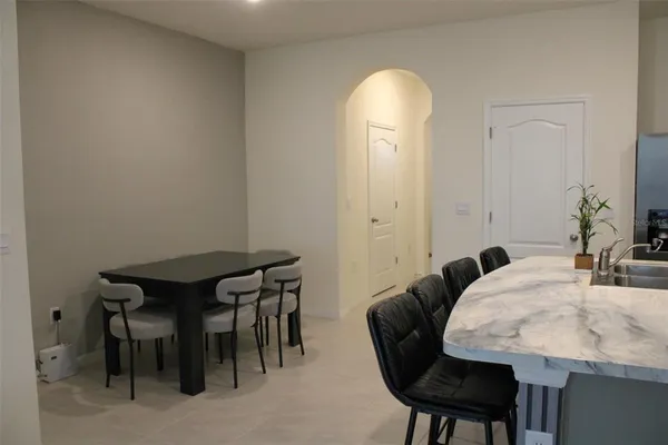 a view of a dining room with furniture and a potted plant