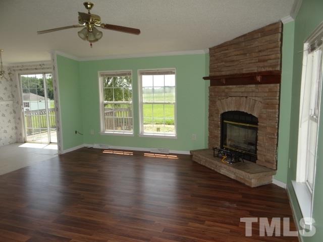 6393 Nichols Rd Spring Spring Hope, NC 27882 - Photo 4 of 15 a view of an empty room with wooden floor fireplace and a window