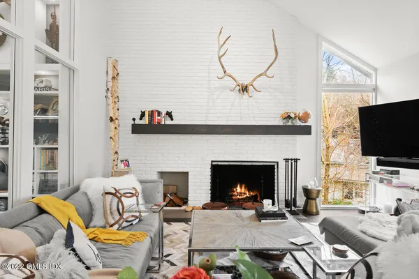 a living room with furniture a fireplace and a flat screen tv