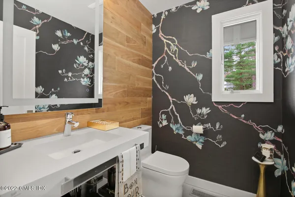 a bathroom with a sink mirror vanity and toilet