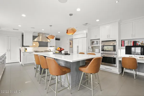 a kitchen with a dining table chairs and a refrigerator