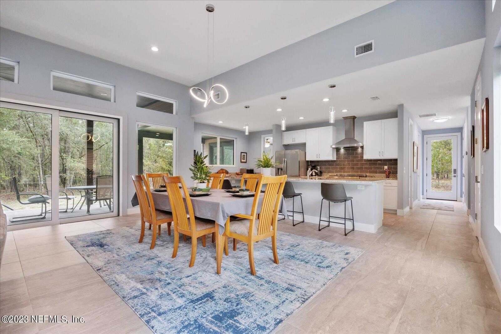 13535 Settindown Drive Bryceville, FL 32009 - Photo 16 of 59 a view of a dining area with furniture window and wooden floor