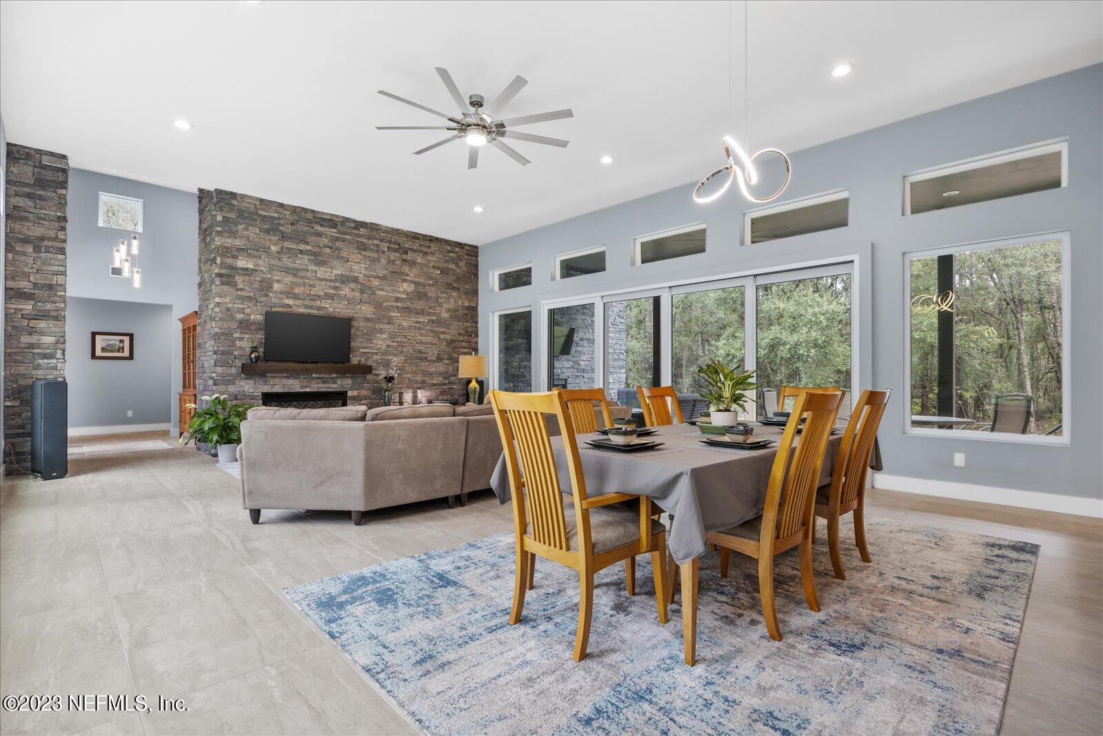 13535 Settindown Drive Bryceville, FL 32009 - Photo 18 of 59 a dining room with furniture a flat screen tv and a large window