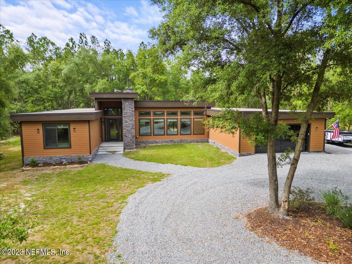 13535 Settindown Drive Bryceville, FL 32009 - Photo 2 of 59 a view of a house with a swimming pool