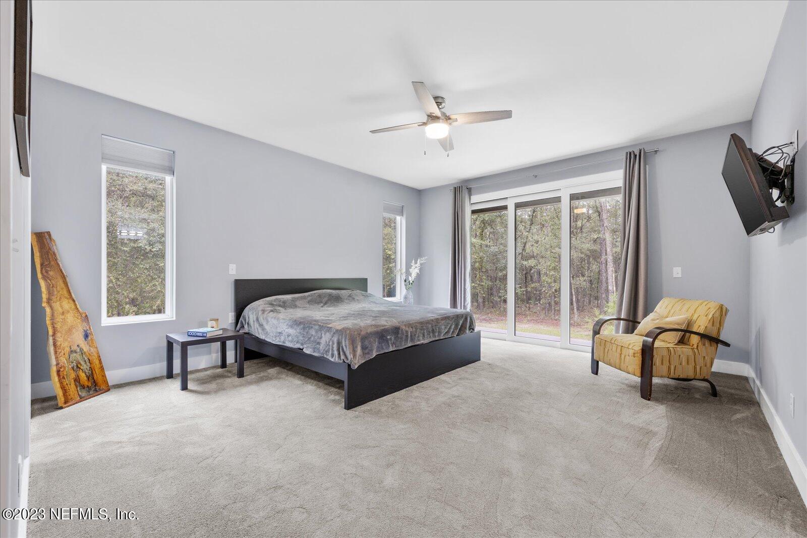 13535 Settindown Drive Bryceville, FL 32009 - Photo 27 of 59 a spacious bedroom with a bed and a window