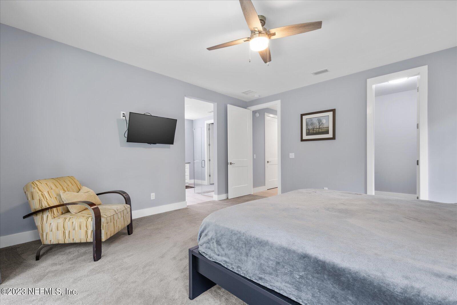 13535 Settindown Drive Bryceville, FL 32009 - Photo 28 of 59 a spacious bedroom with a bed and a couch