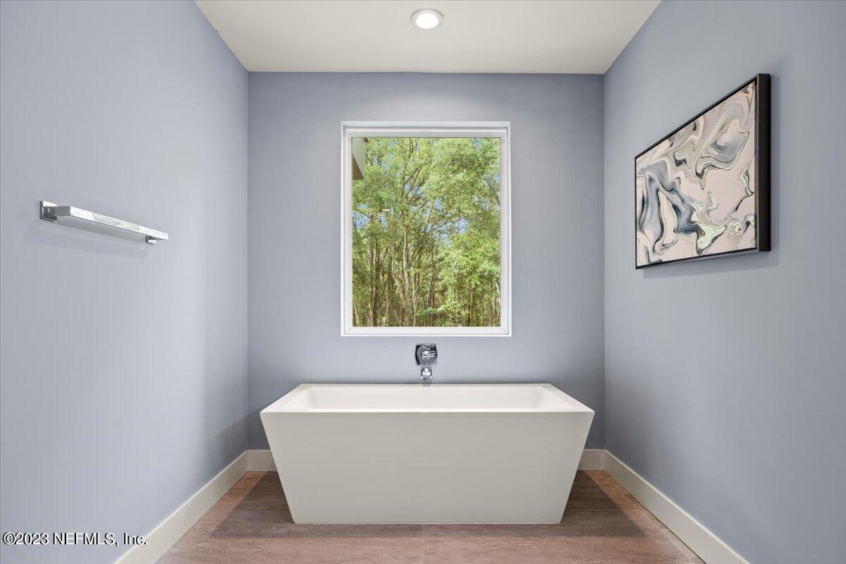 13535 Settindown Drive Bryceville, FL 32009 - Photo 29 of 59 a white tub sitting in a bathroom next to a window