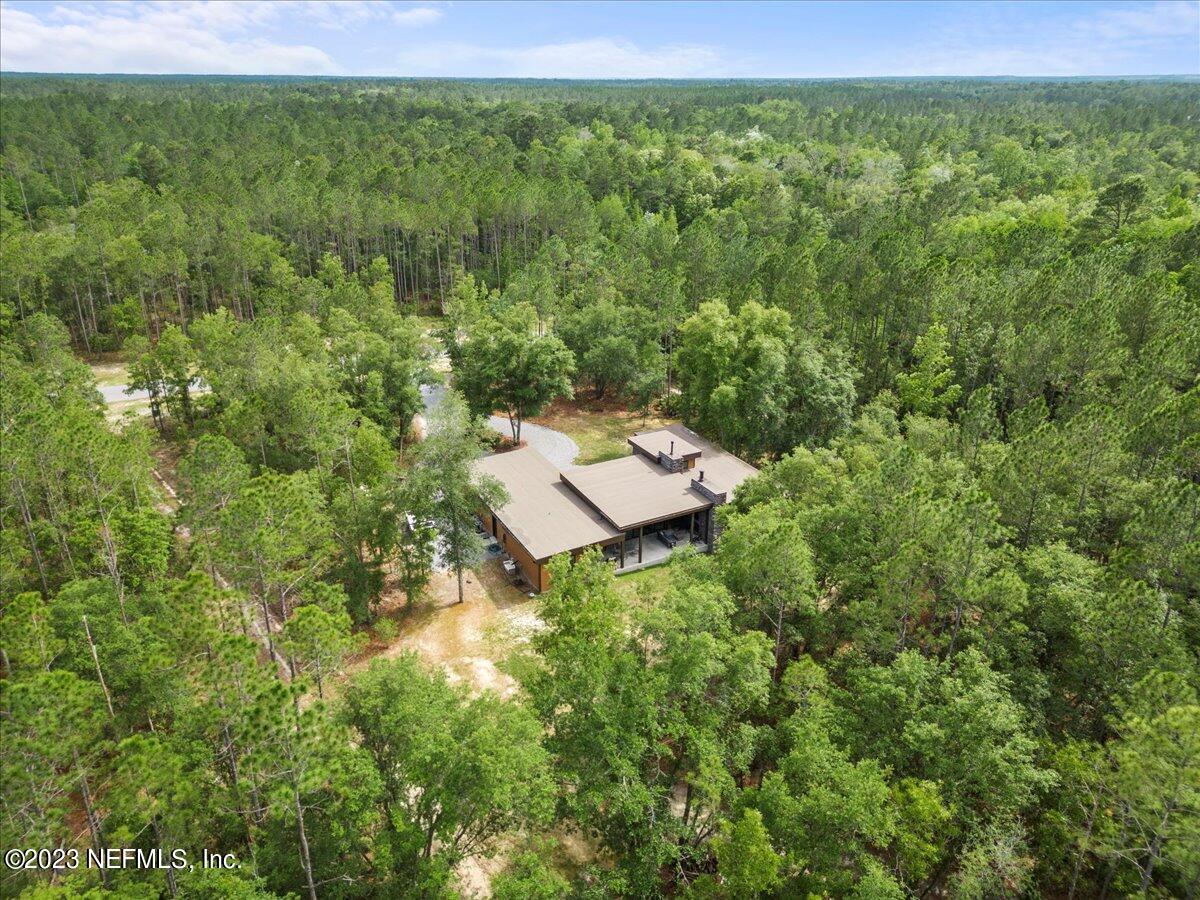 13535 Settindown Drive Bryceville, FL 32009 - Photo 3 of 59 a backyard of a house with lots of green space and a forest