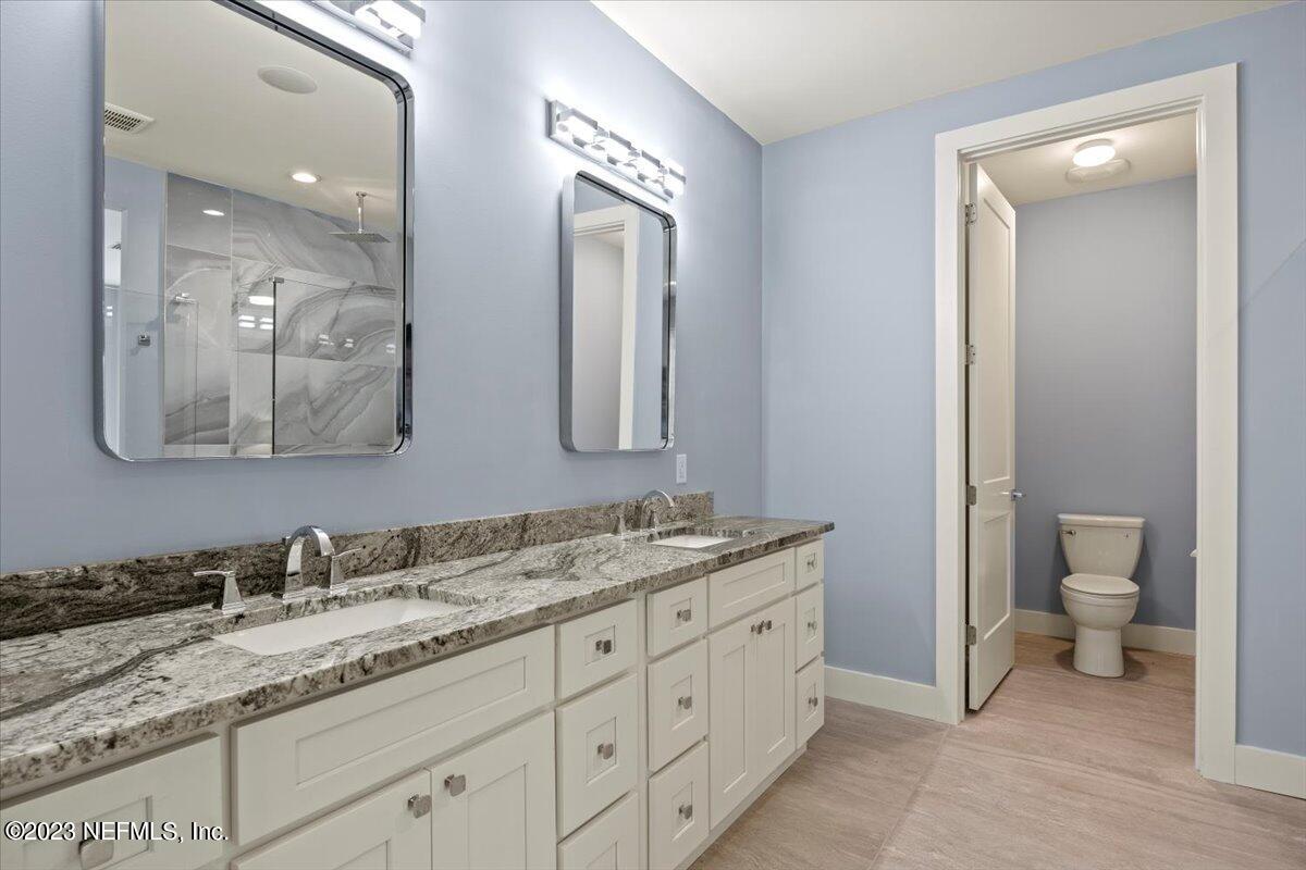 13535 Settindown Drive Bryceville, FL 32009 - Photo 31 of 59 a bathroom with a granite countertop sink mirror and toilet