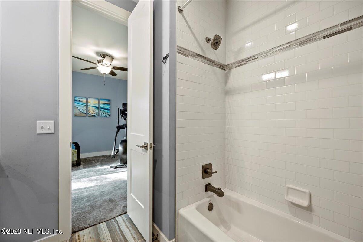 13535 Settindown Drive Bryceville, FL 32009 - Photo 35 of 59 a bathroom with a bathtub and a shower