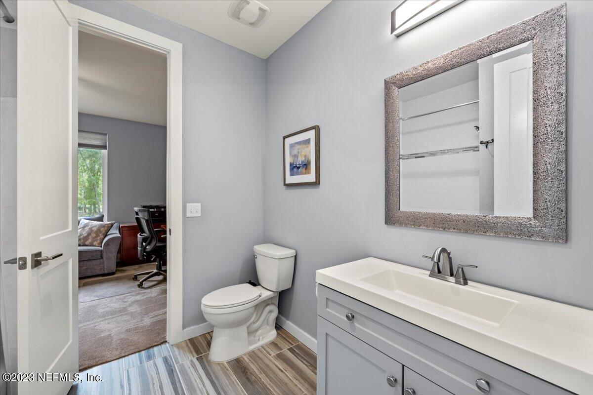 13535 Settindown Drive Bryceville, FL 32009 - Photo 36 of 59 a bathroom with a toilet a sink and a mirror