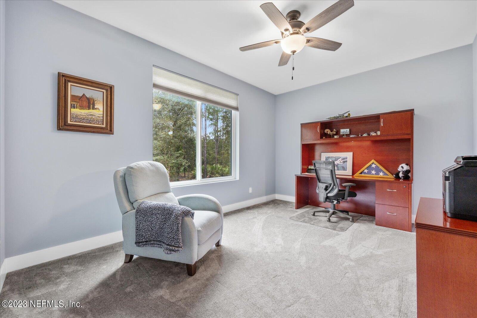 13535 Settindown Drive Bryceville, FL 32009 - Photo 38 of 59 a living room with furniture and a flat screen tv