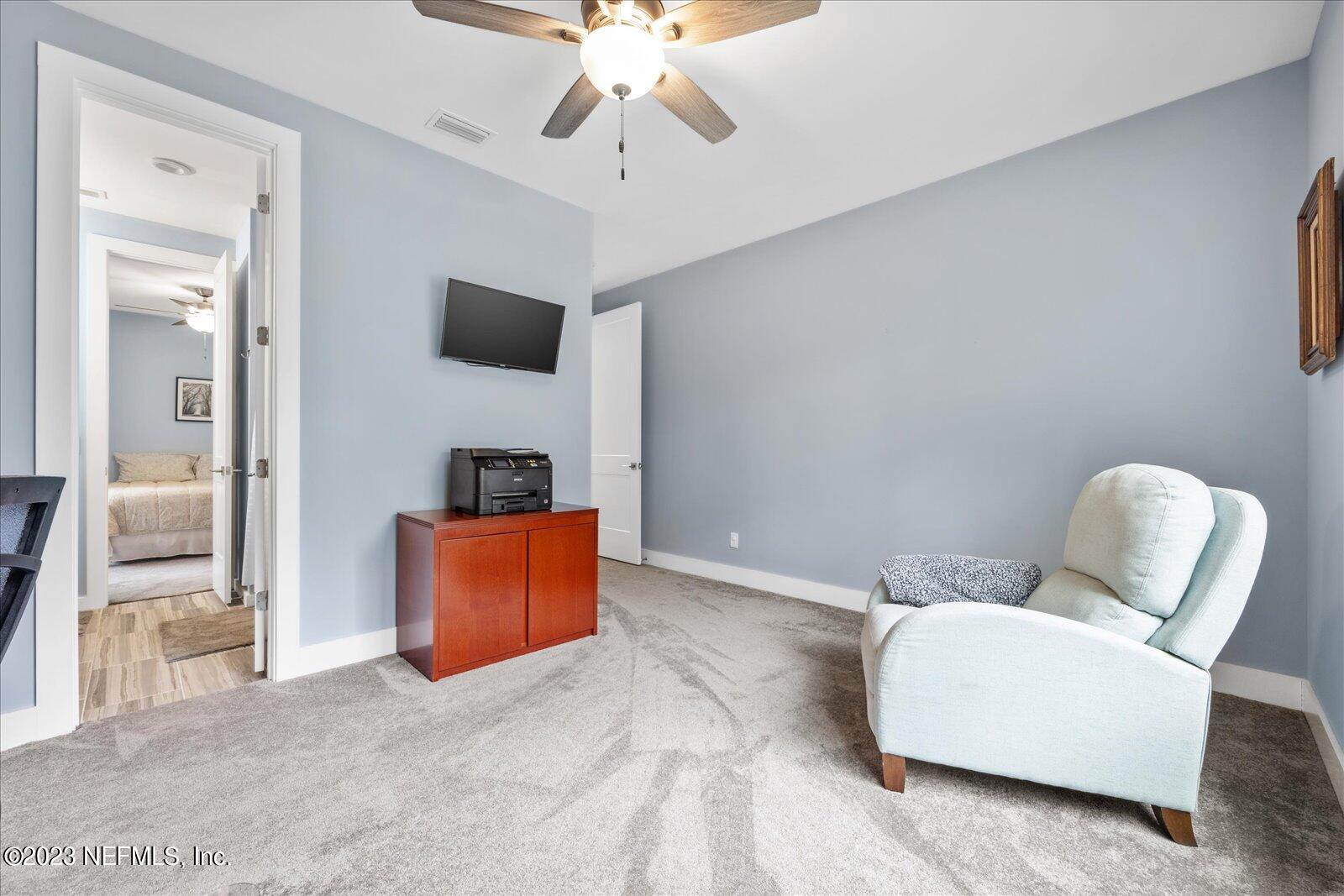 13535 Settindown Drive Bryceville, FL 32009 - Photo 39 of 59 a living room with furniture and a flat screen tv