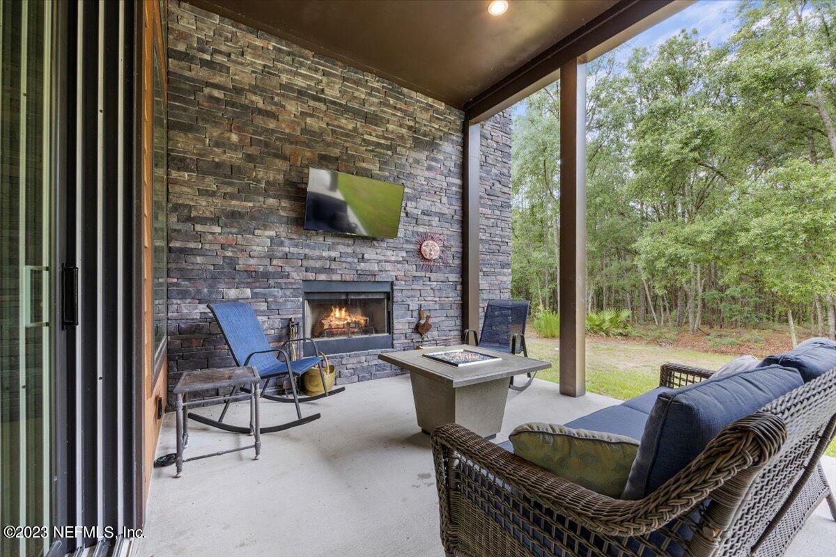 13535 Settindown Drive Bryceville, FL 32009 - Photo 46 of 59 a outdoor living space with furniture and a fireplace