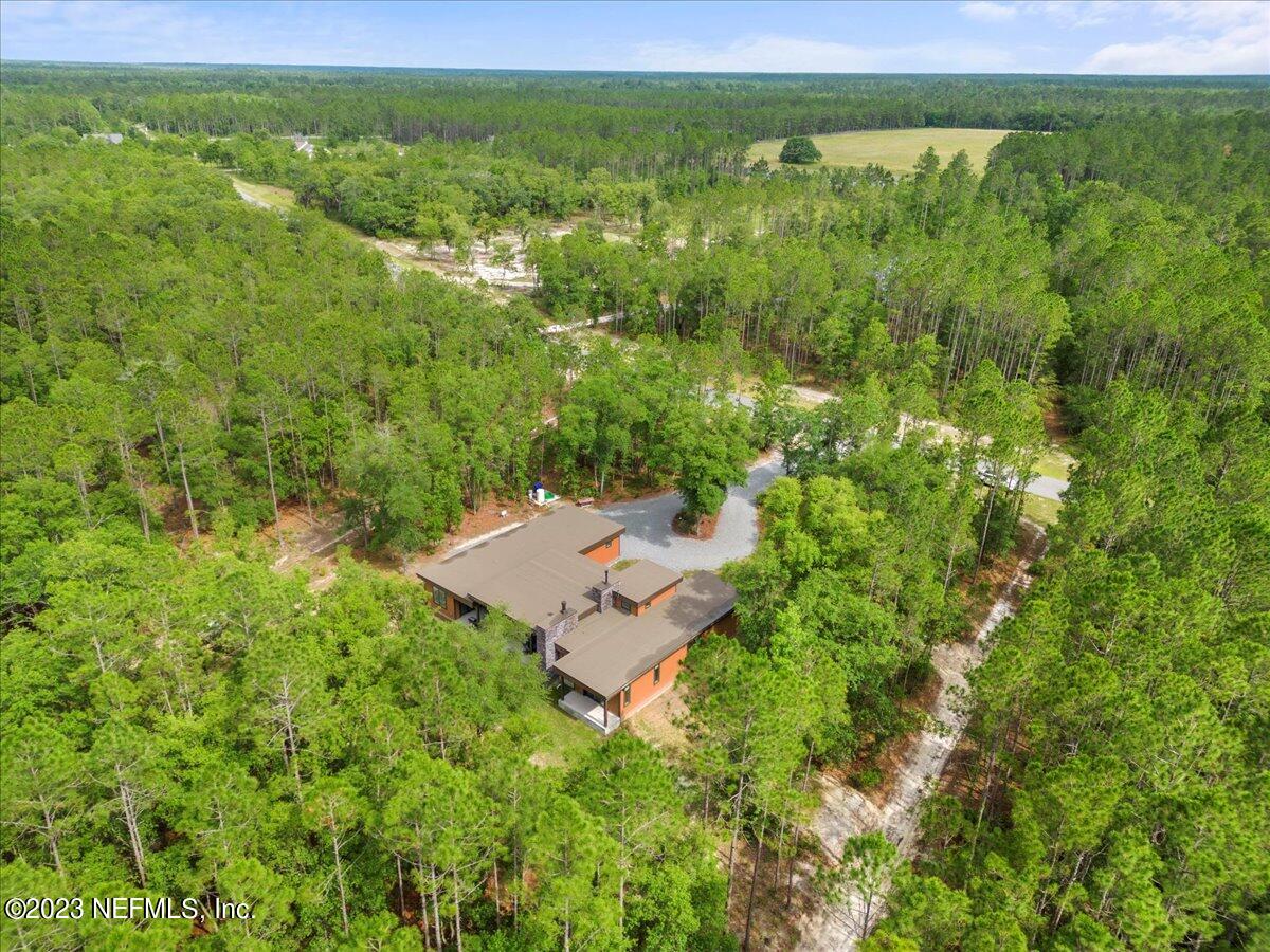 13535 Settindown Drive Bryceville, FL 32009 - Photo 52 of 59 a view of a garden with a building in the back yard