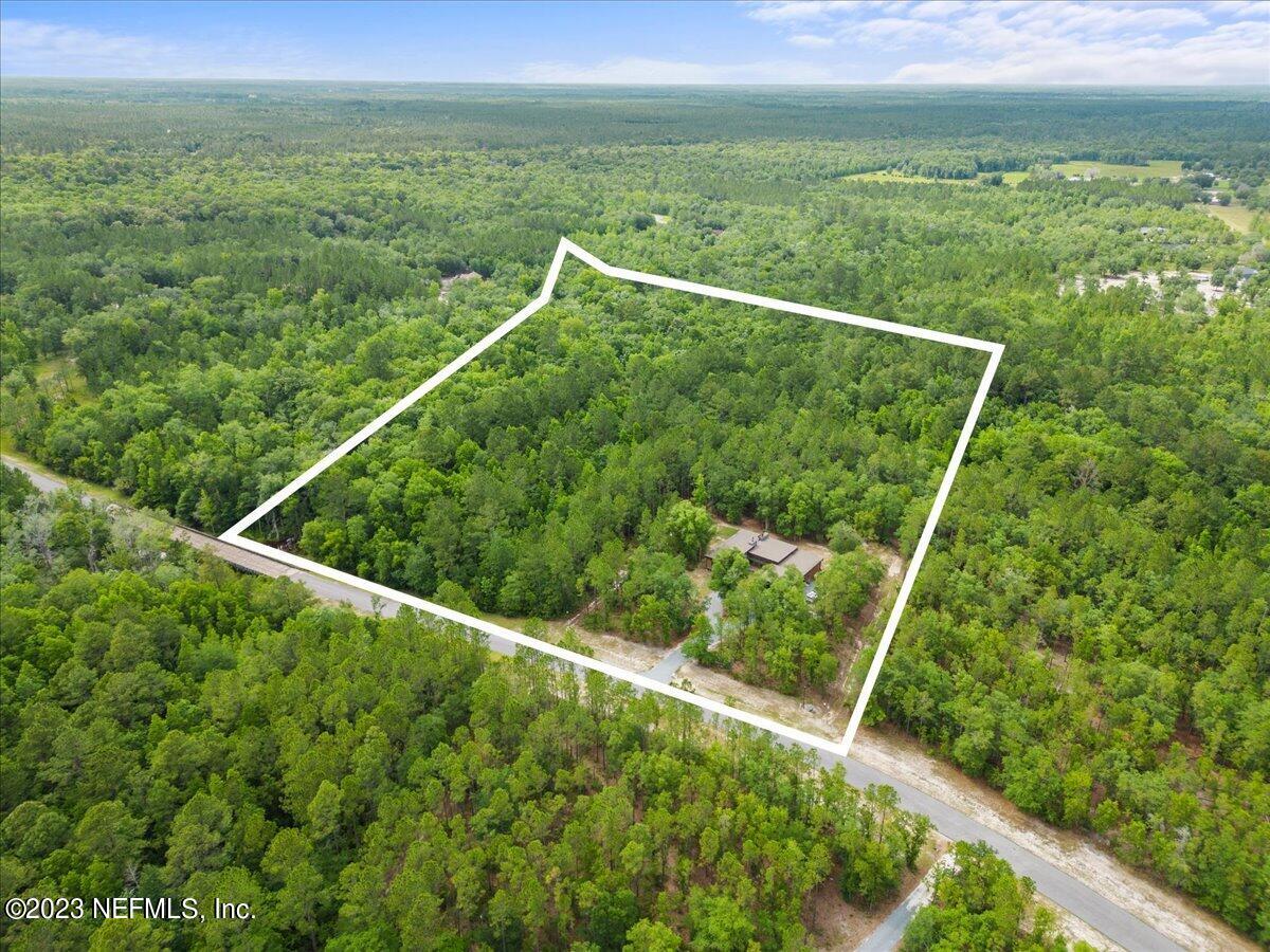 13535 Settindown Drive Bryceville, FL 32009 - Photo 6 of 59 a view of a lush green forest from a balcony