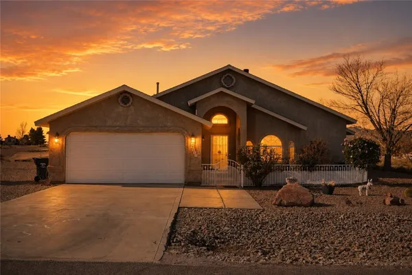 a kitchen with stainless steel appliances granite countertop a stove a sink dishwasher and a refrigerator with wooden floor
