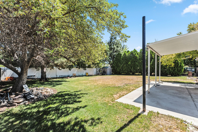 8843 Capernaum Road West Jordan, UT 84088 - Photo 25 of 31 Fenced backyard featuring a storage unit