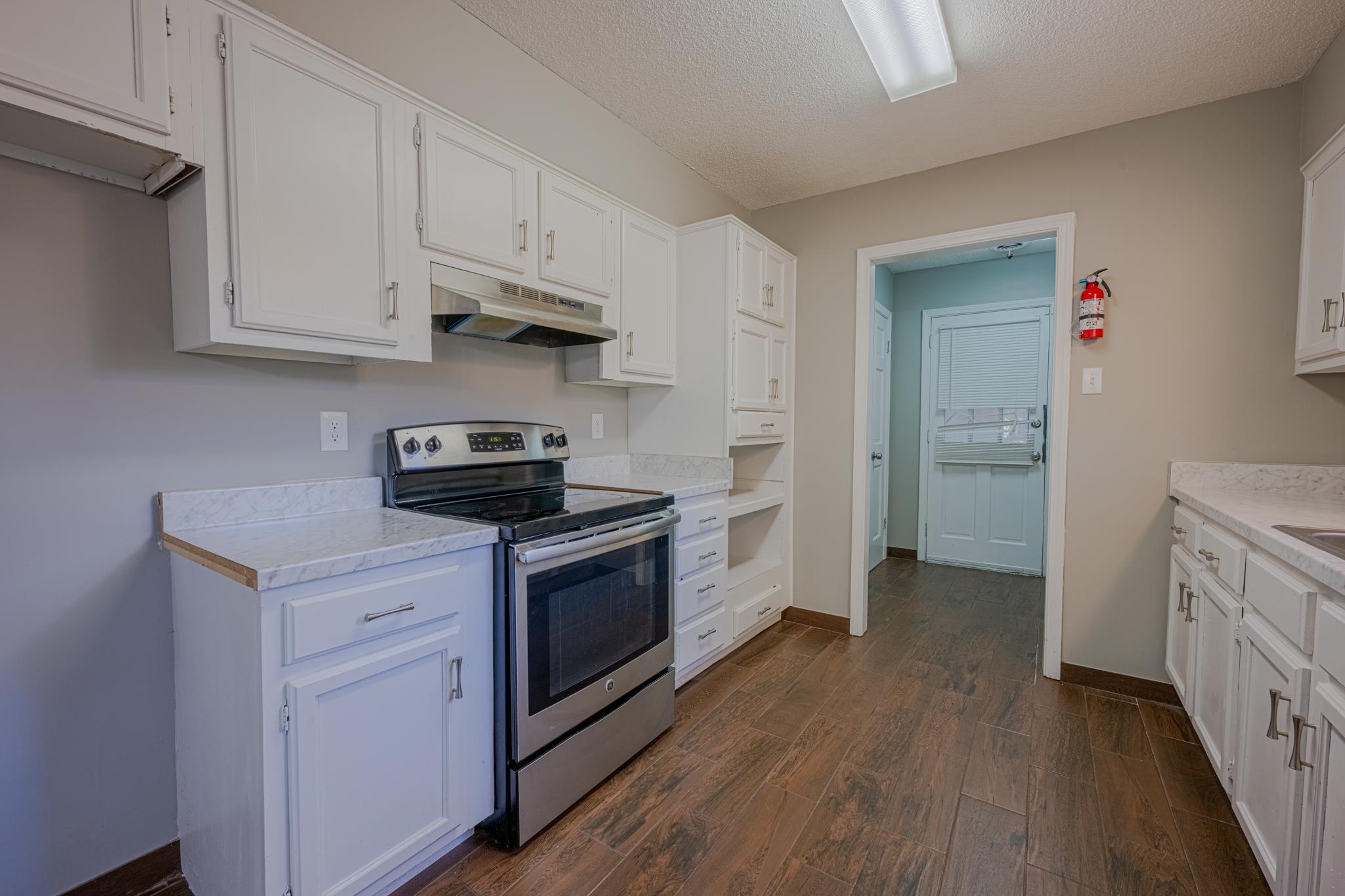 7125 Crestridge Road Memphis, TN 38119 - Photo 13 of 36 a kitchen with stainless steel appliances granite countertop a stove and a refrigerator