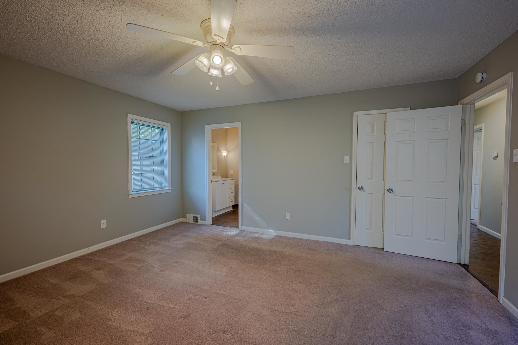 7125 Crestridge Road Memphis, TN 38119 - Photo 17 of 36 a view of an empty room with a chandelier fan