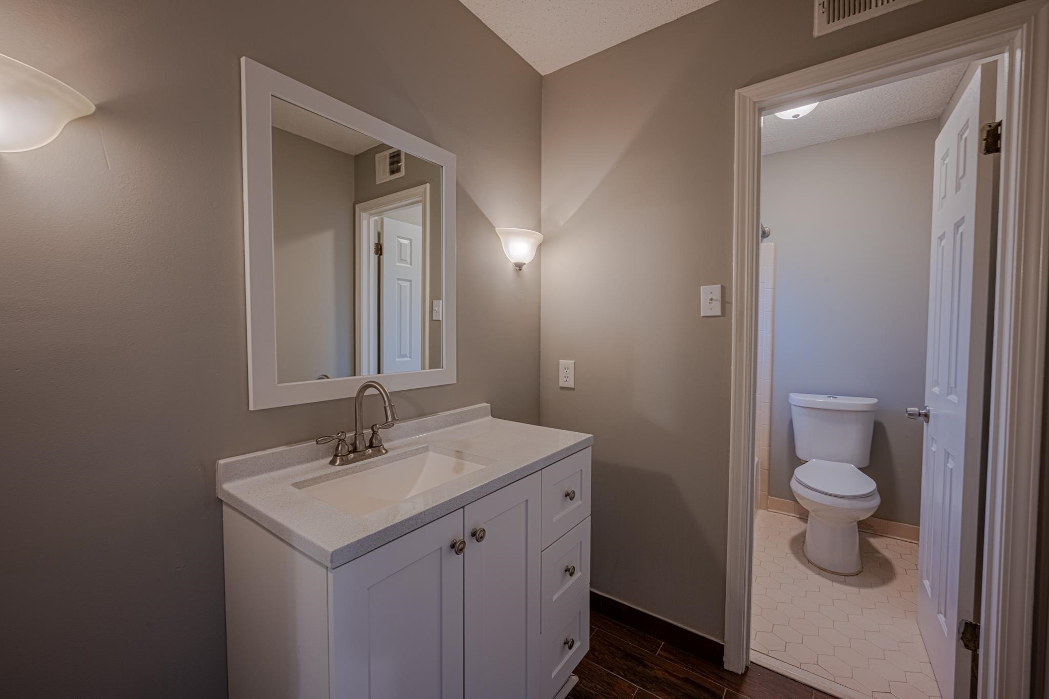 7125 Crestridge Road Memphis, TN 38119 - Photo 18 of 36 a bathroom with a sink a toilet and a mirror