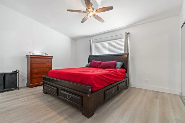 a bedroom with a bed and a flat screen tv