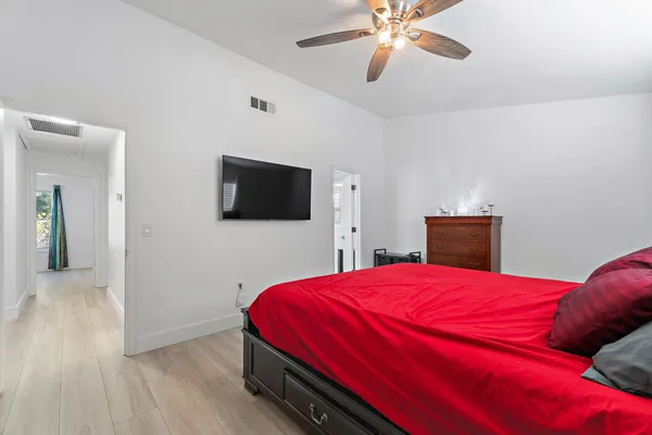 a bedroom with a bed and a flat screen tv