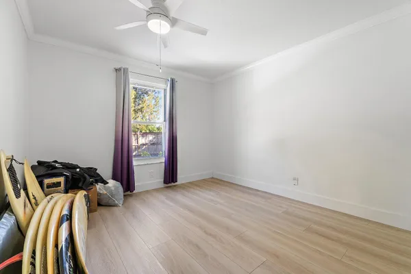 a view of a room with wooden floor and windows