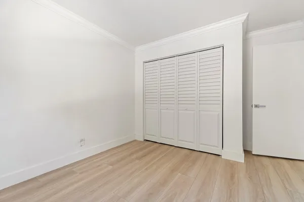 a bathroom with a granite countertop sink toilet mirror and shower