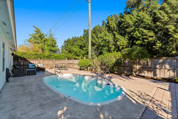 a view of a patio with a table and chairs