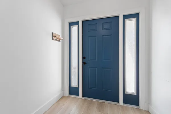 a living room with furniture a rug and a chandelier