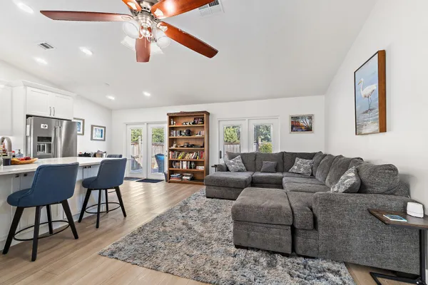 a living room with furniture and a book shelf