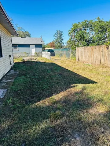 a view of a backyard with plants and lake view