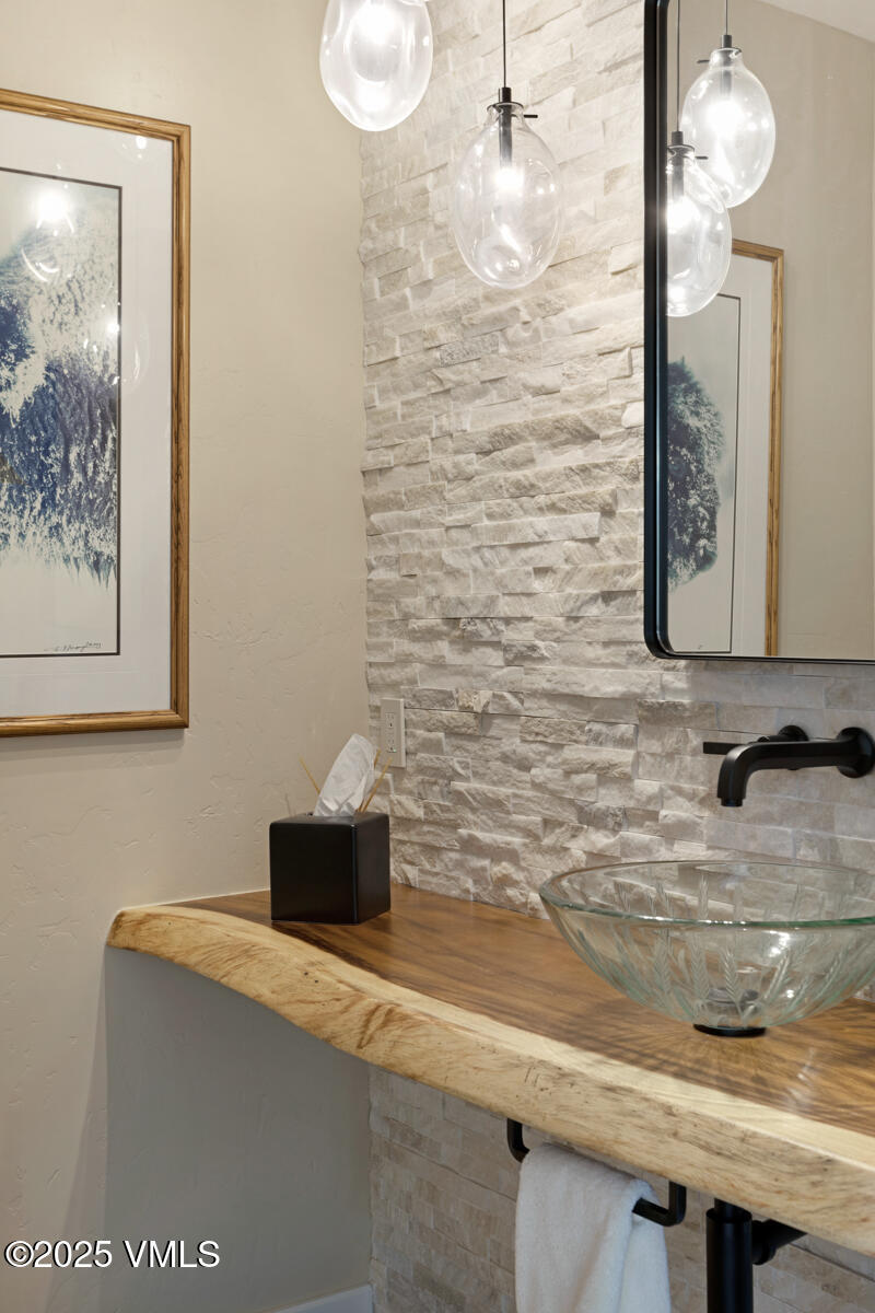 130 Fall Creek Road Edwards, CO 81632 - Photo 22 of 52 a bathroom with a granite countertop sink a mirror and vanity