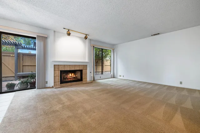 a view of empty room with a fireplace