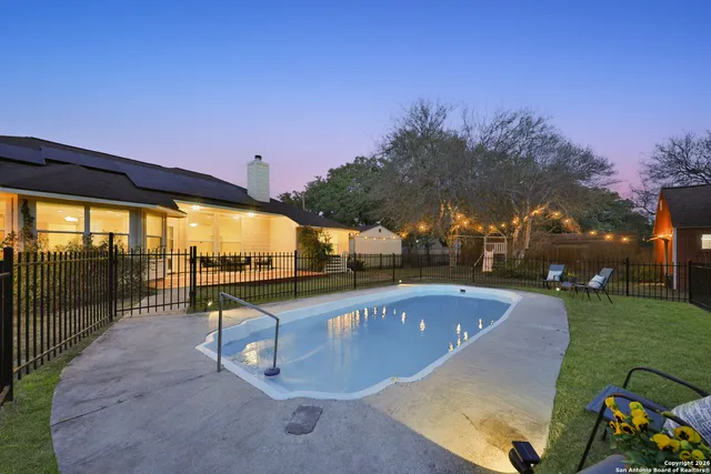 a swimming pool with outdoor seating and yard