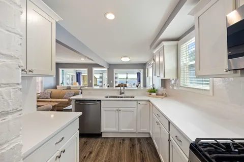 a kitchen with a sink stove and cabinets